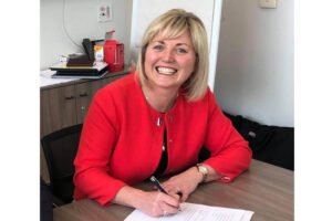 Cllr Sharon Tolan seated at a desk