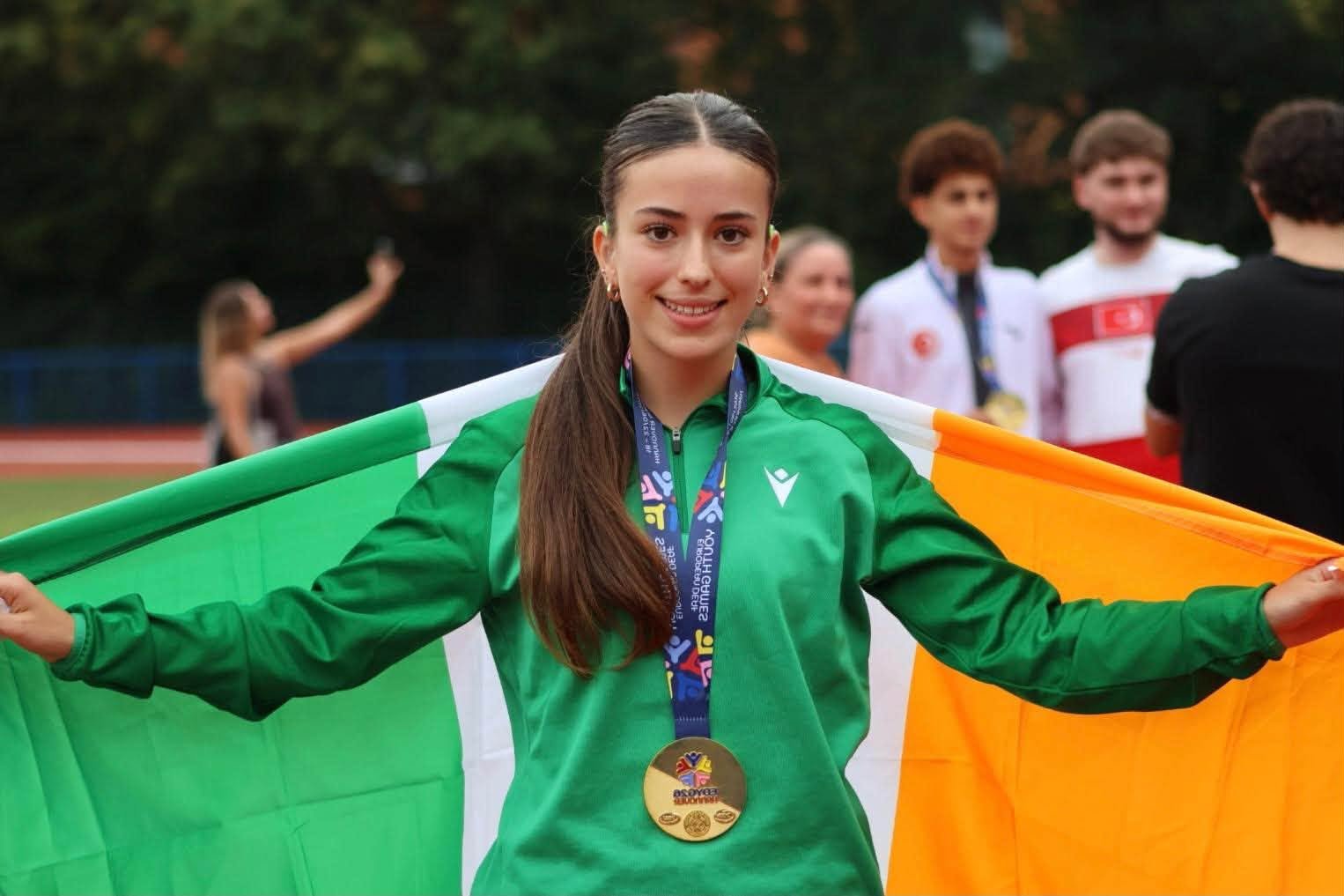 Beatrice Cunningham celebrates after winning gold in the 800m for Ireland at the inaugural European Deaf Youth Games in Hannover. Beatrice Cunningham wearing her gold medal and holding the Irish flag at the European Deaf Youth Games