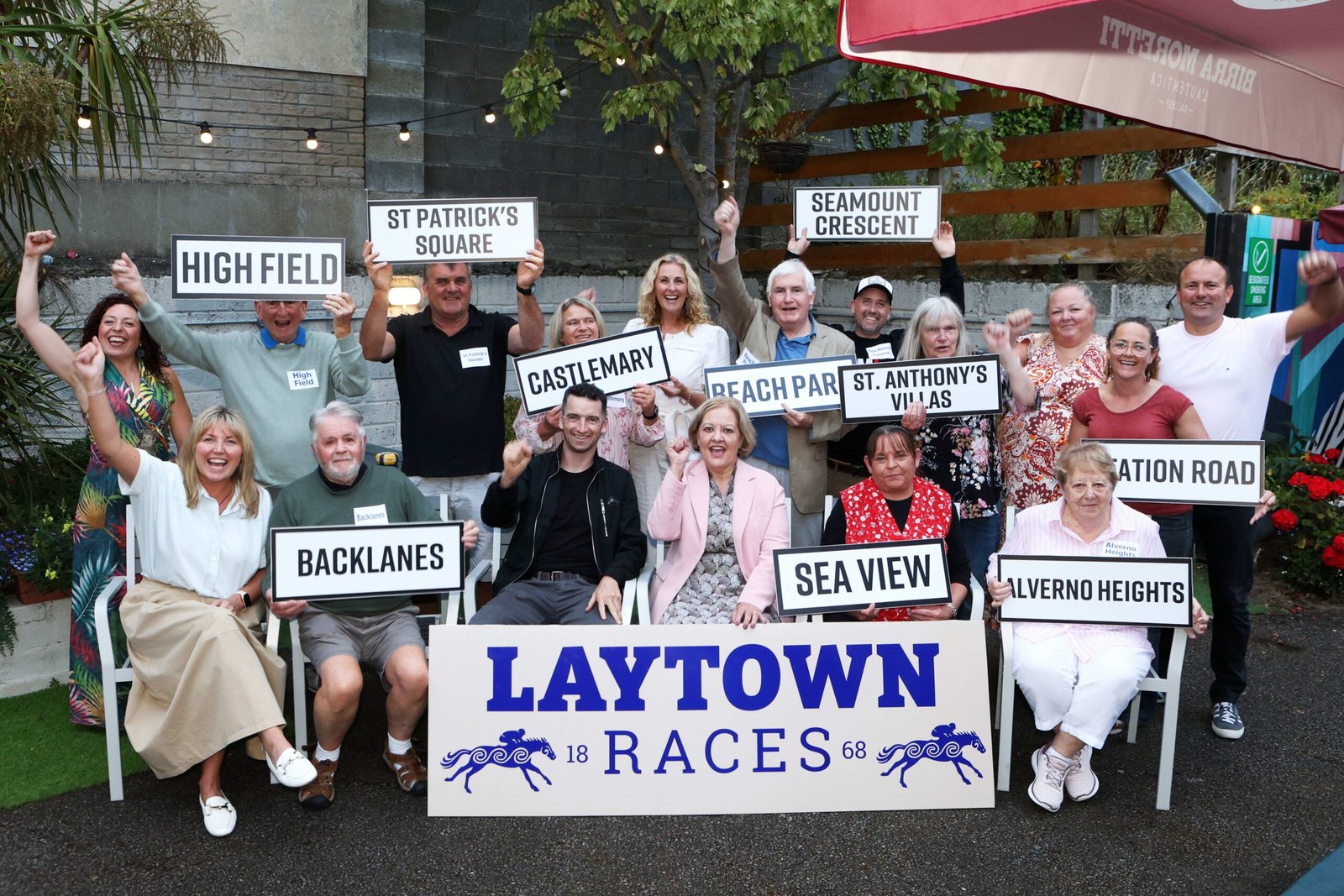 Laytown residents holding estate signs at the Pride of Place draw for Laytown Races 2026