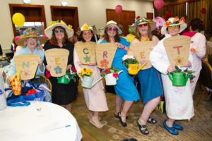Women dressed in colourful outfits at a Northeast Dip in the Nip fundraising event