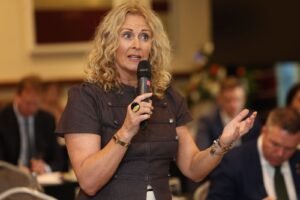 Senator Alison Comyn speaking at a political meeting