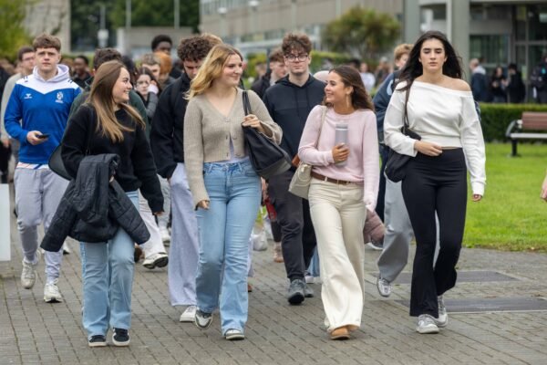 New first-year students walking across the DkIT campus during induction