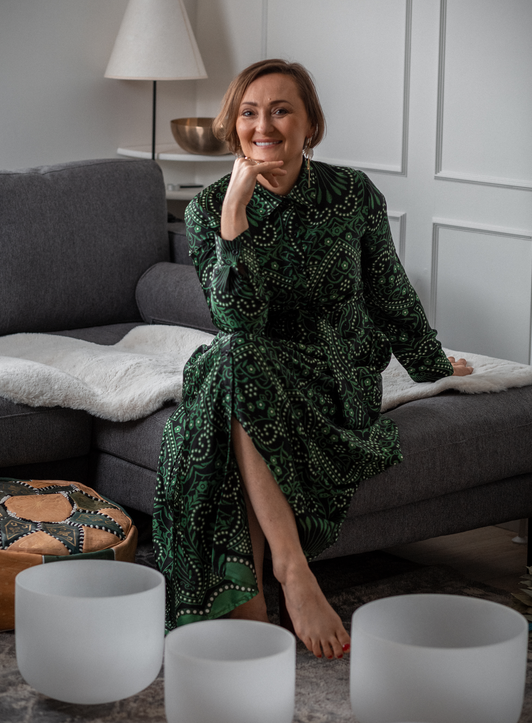 A reflective wellbeing image accompanying Drogheda Life’s September column on slowing down, seasonal change and protecting balance as routines return. Woman seated indoors beside wellbeing bowls in a calm home setting