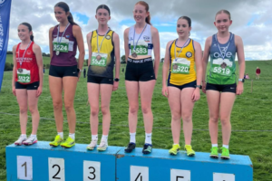 Young athletes standing on the podium after competing at the Star AC cross country