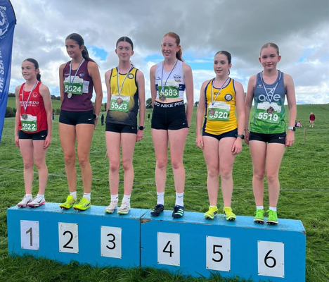 Young athletes standing on the podium after competing at the Star AC cross country