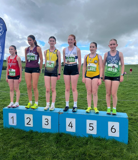 Young athletes standing on the podium after competing at the Star AC cross country