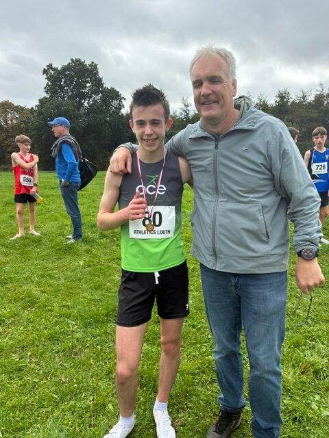 Taylor Gregory of Ace AC pictured with coach Ian O’Reilly after the Louth Cross Country Championships