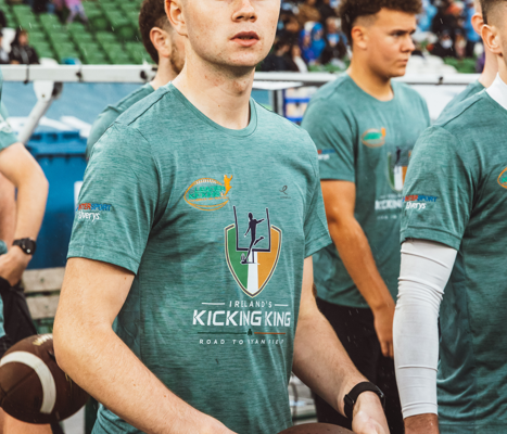 Tiernan Markey holding an American football during Ireland’s Kicking King event at Aviva Stadium