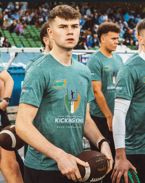 Tiernan Markey holding an American football during Ireland’s Kicking King event at Aviva Stadium